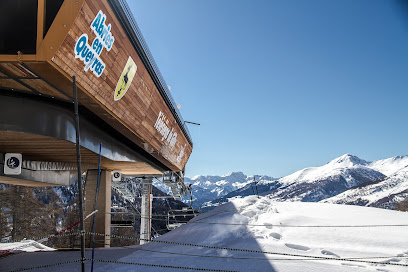 A picturesque view of a ski resort in Abriès France featuring a charming chalet amidst a popular winter sports scene enhanced by a cosy mountain hut.