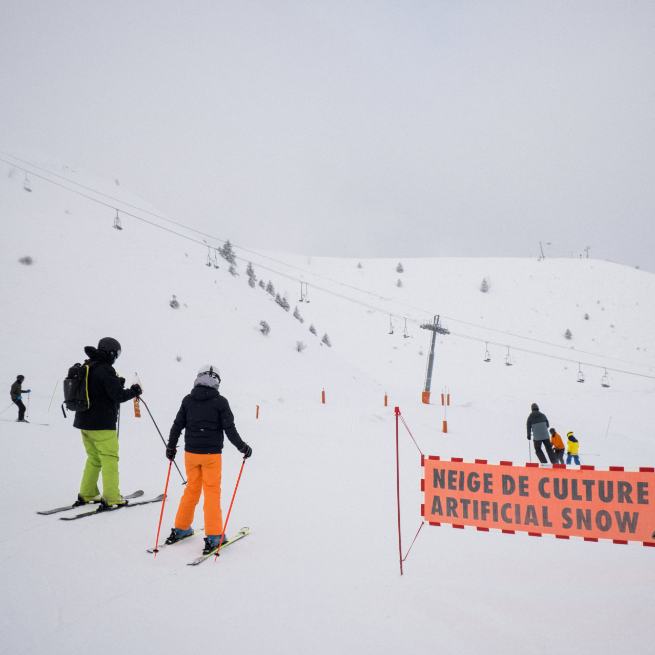Métabief in France - a group of people skiing down a snowy hill.