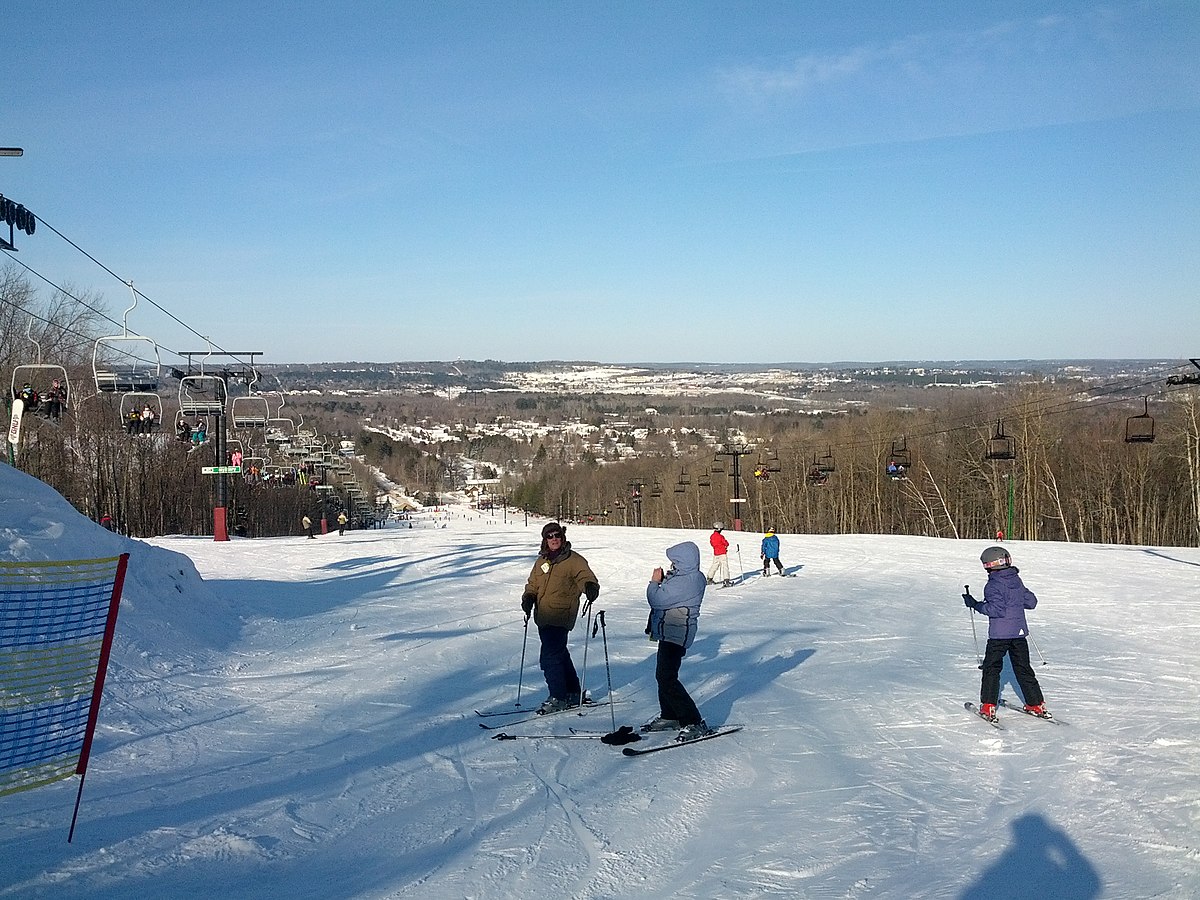 Granite Peak at Rib Mountain State Park in USA - a group of people riding ski boards down a hill.