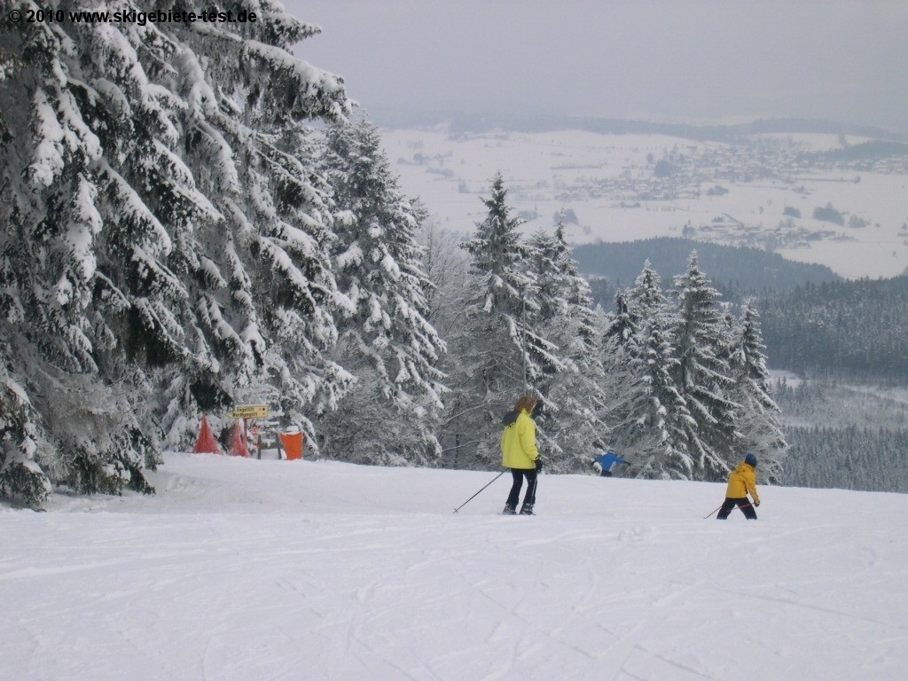 Pröller Skidreieck in Germany - two people are skiing down a snowy hill.