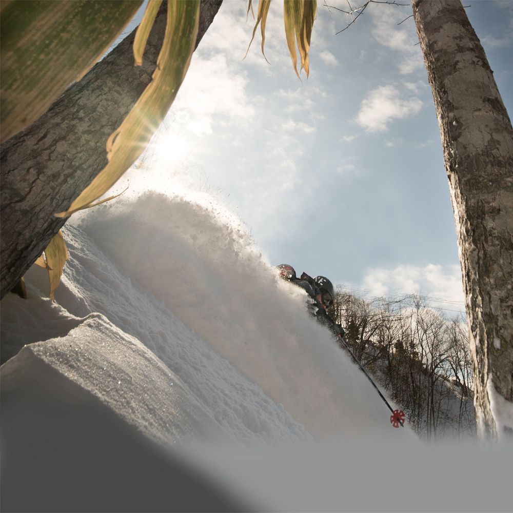 Yubari Resort – Mount Racey in Japan - a person on a snowboard in the air.