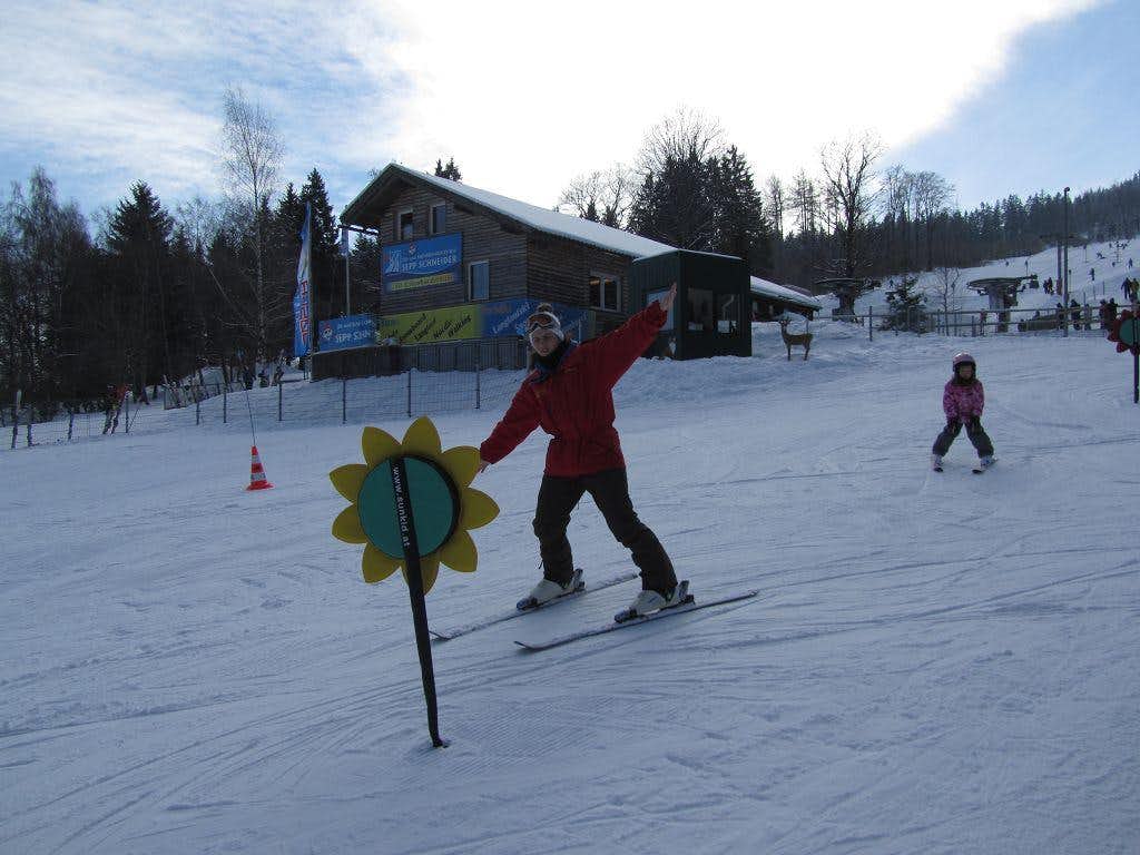 Geißkopf – Bischofsmais in Germany - a person riding a snowboard down a snow covered slope.