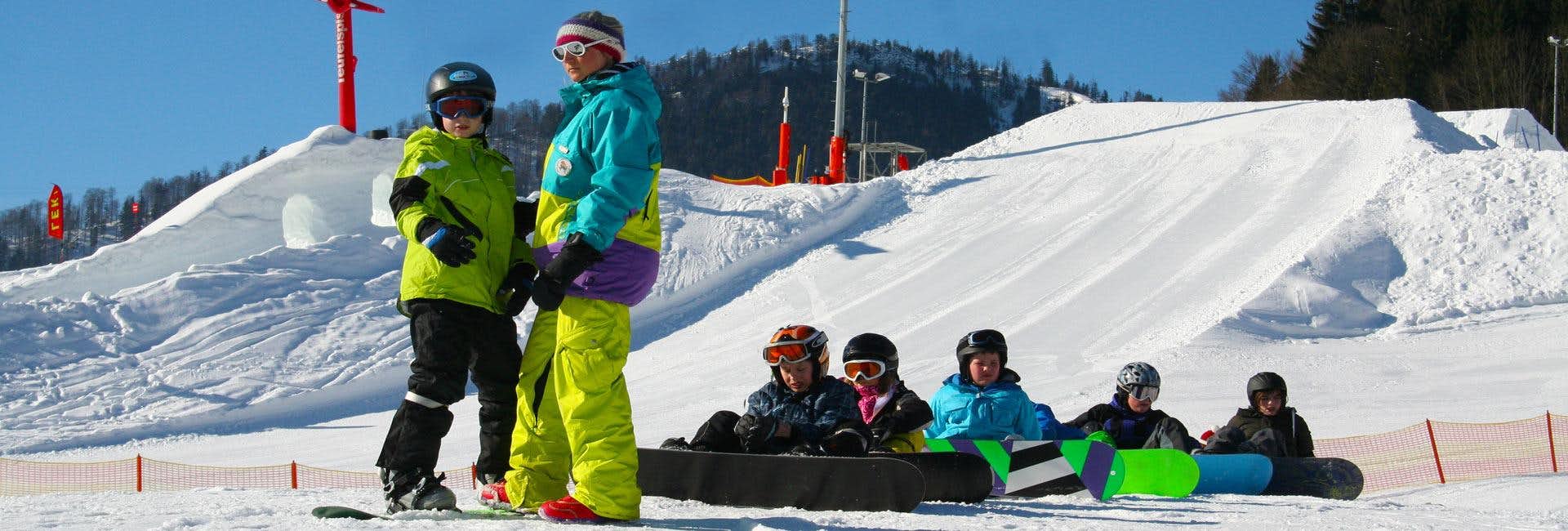 Geißkopf – Bischofsmais in Germany - a group of people sitting on top of a snow covered slope.