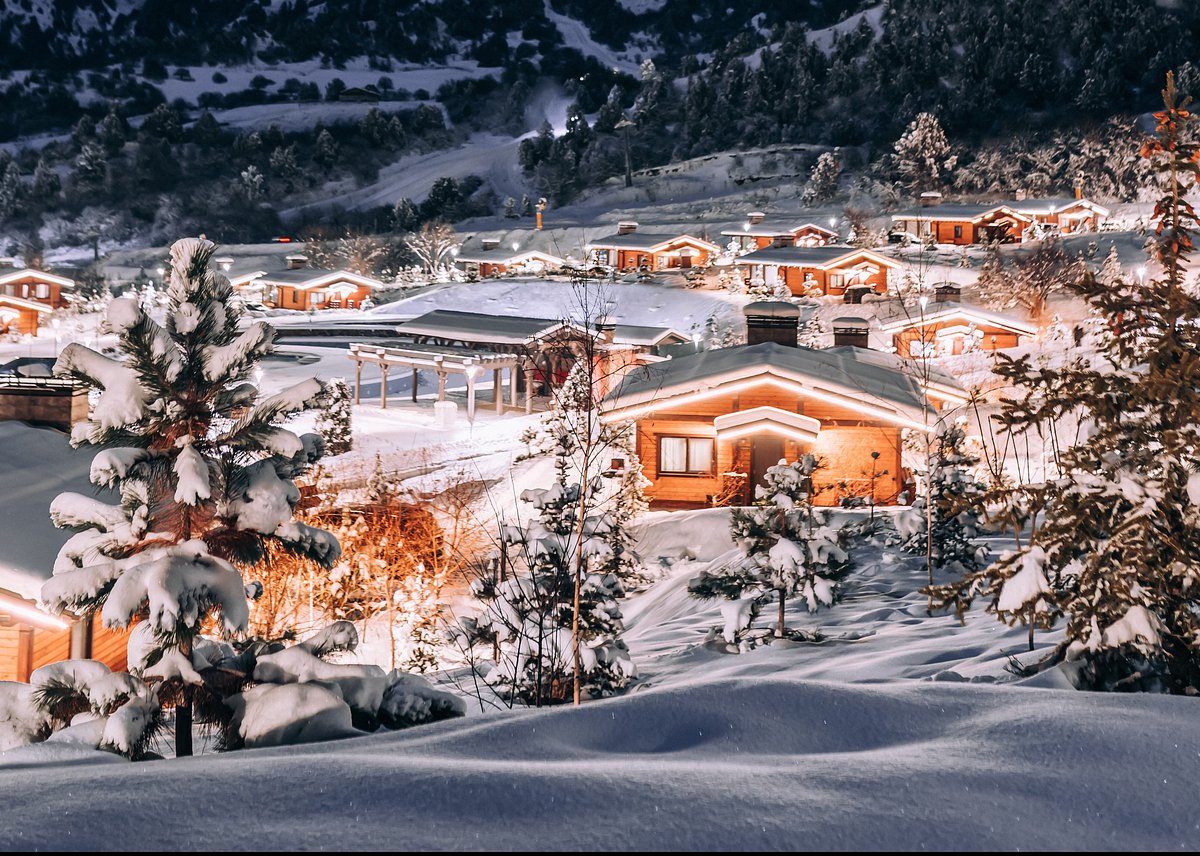 Amirsoy Mountain Resort in Uzbekistan - a small town covered in snow at night.