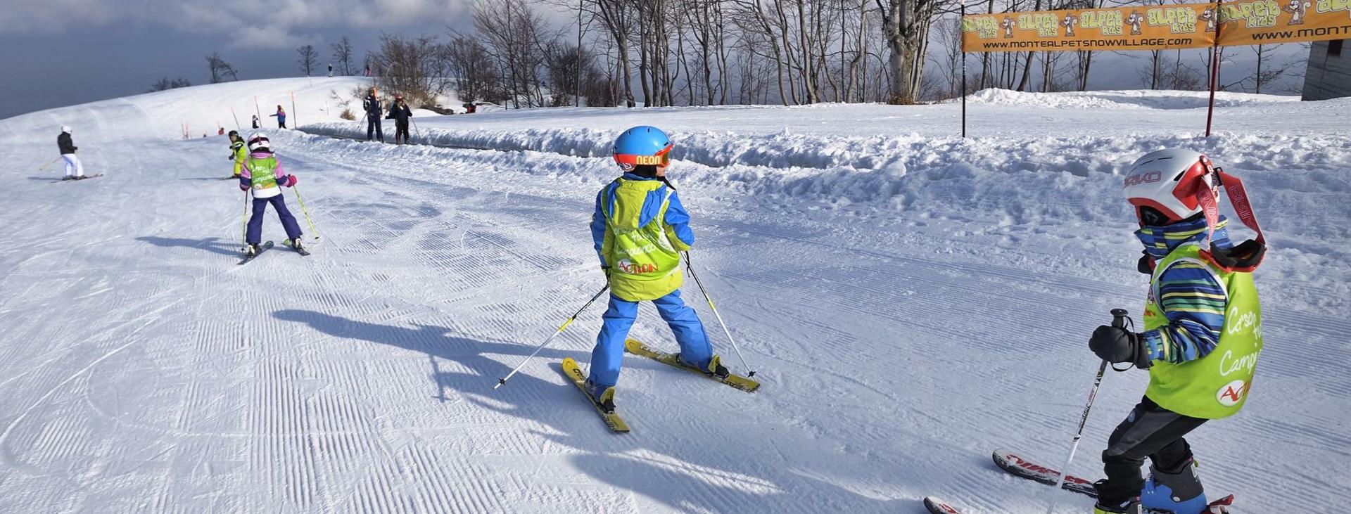 Sangiacomo Cardini – Monte Alpet in Italy - a group of people riding ski boards down a slope.