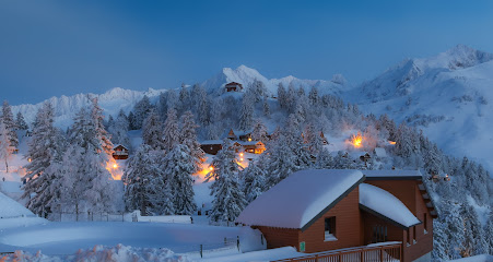 Winter scene at Sangiacomo Cardini – Monte Alpet ski resort in Piedmont, Italy, featuring a chalet nestled in the snow-covered mountains, home for winter sports activities.