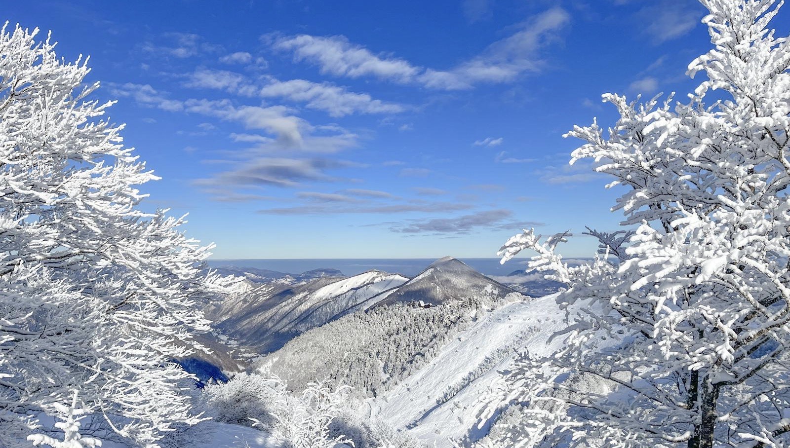 A stunning winter scene in Guzet-Neige, Ariège, France, showcasing a picturesque snowy mountain and winter sports scene against a serene landscape.