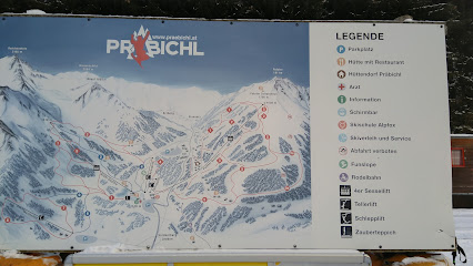 Overlooking the Präbichl ski resort in Vordernberg Austria where a chalet stands amidst white-covered slopes. A ski lift transports eager enthusiasts contributing to the vibrant winter sports scene.