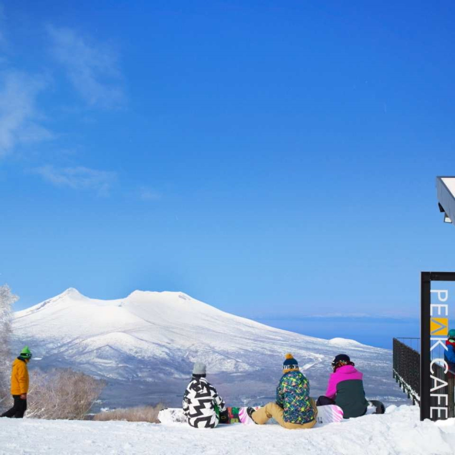 Hakodate Nanae in Japan - a group of people sitting on top of a mountain.