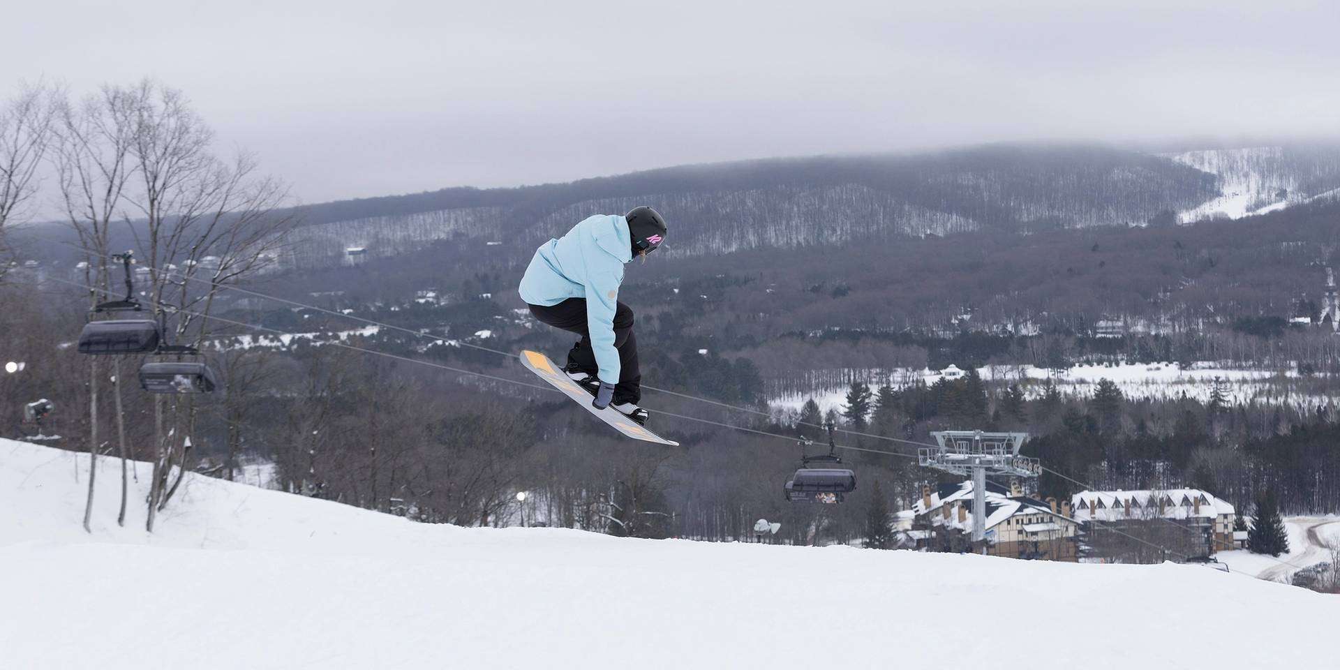 The Highlands at Harbor Springs in USA - a person on a snowboard in the air.