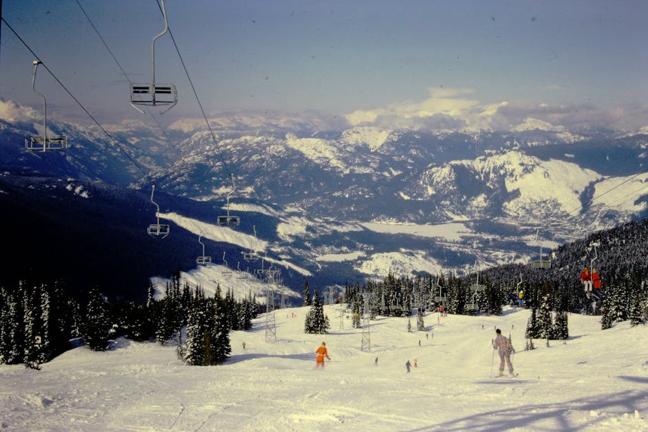 Whistler Blackcomb in Canada - a group of people skiing down a snowy slope.