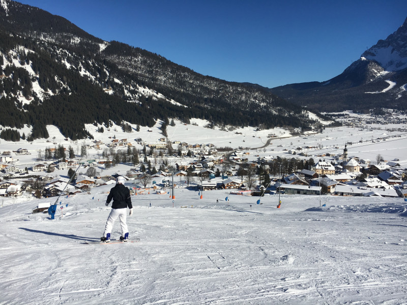 Grubigsteinbahnen Lermoos in Austria - a person on a snowboard in the snow.