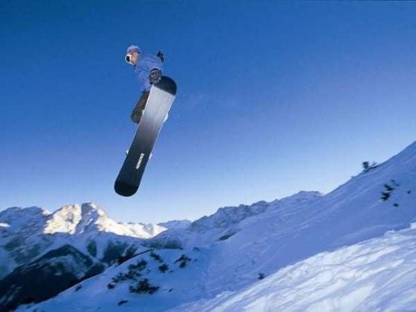Grubigsteinbahnen Lermoos in Austria - a man flying through the air while riding a snowboard.