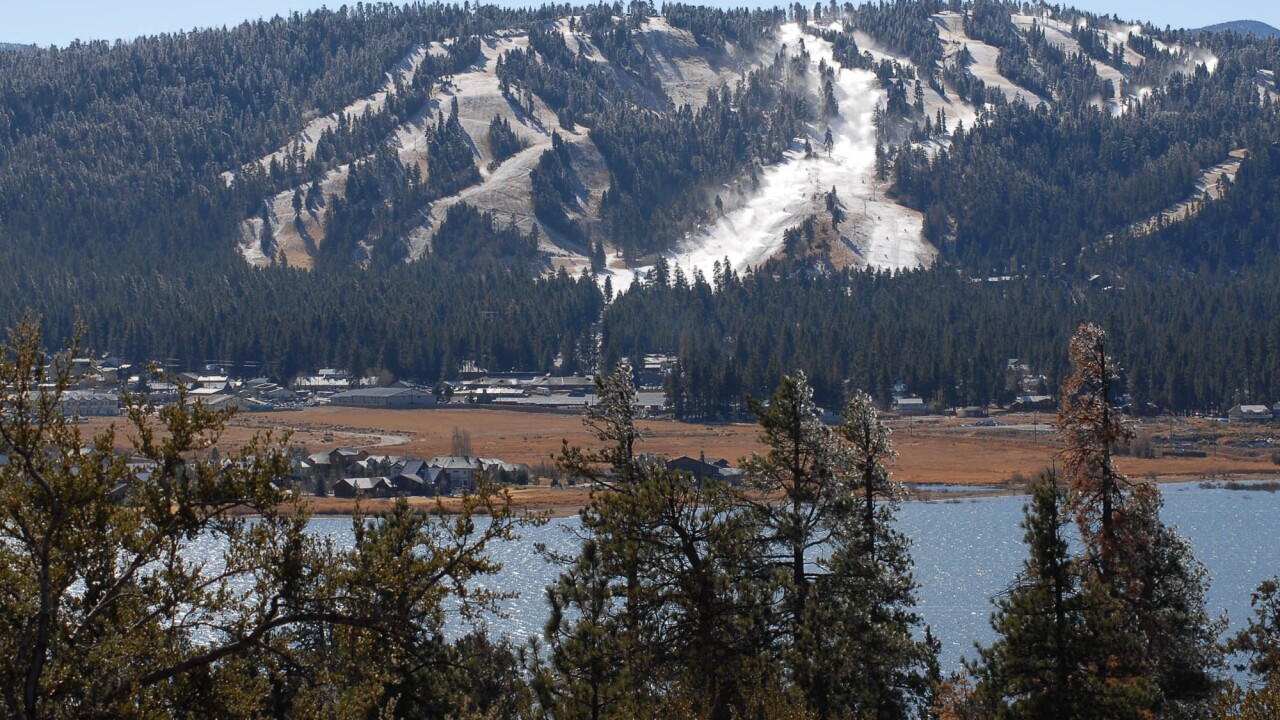 Snow Summit in USA - a view of a mountain with trees and a lake.