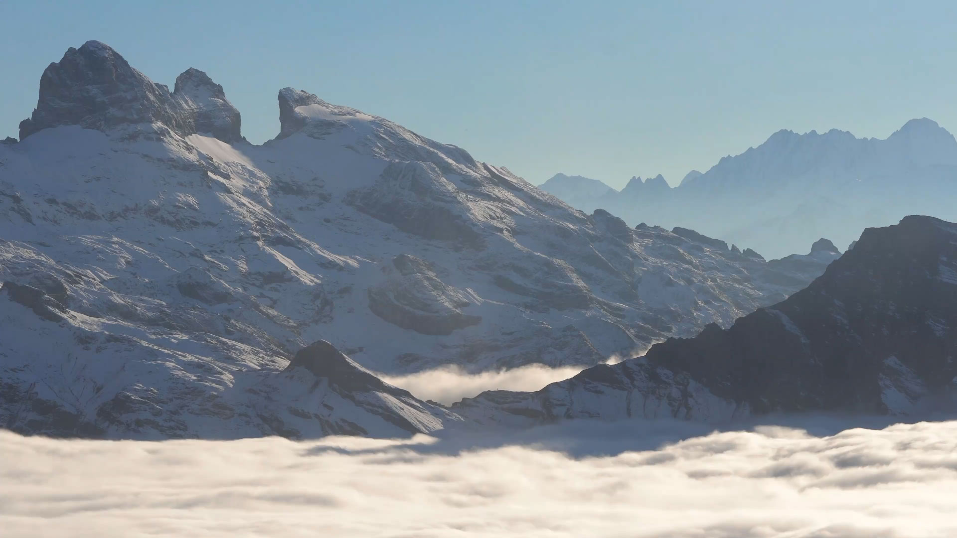 View of Snow Summit in Big Bear Lake, California showcasing a majestic snowy mountain landscape, detailed with a charming chalet and active winter sports scene.