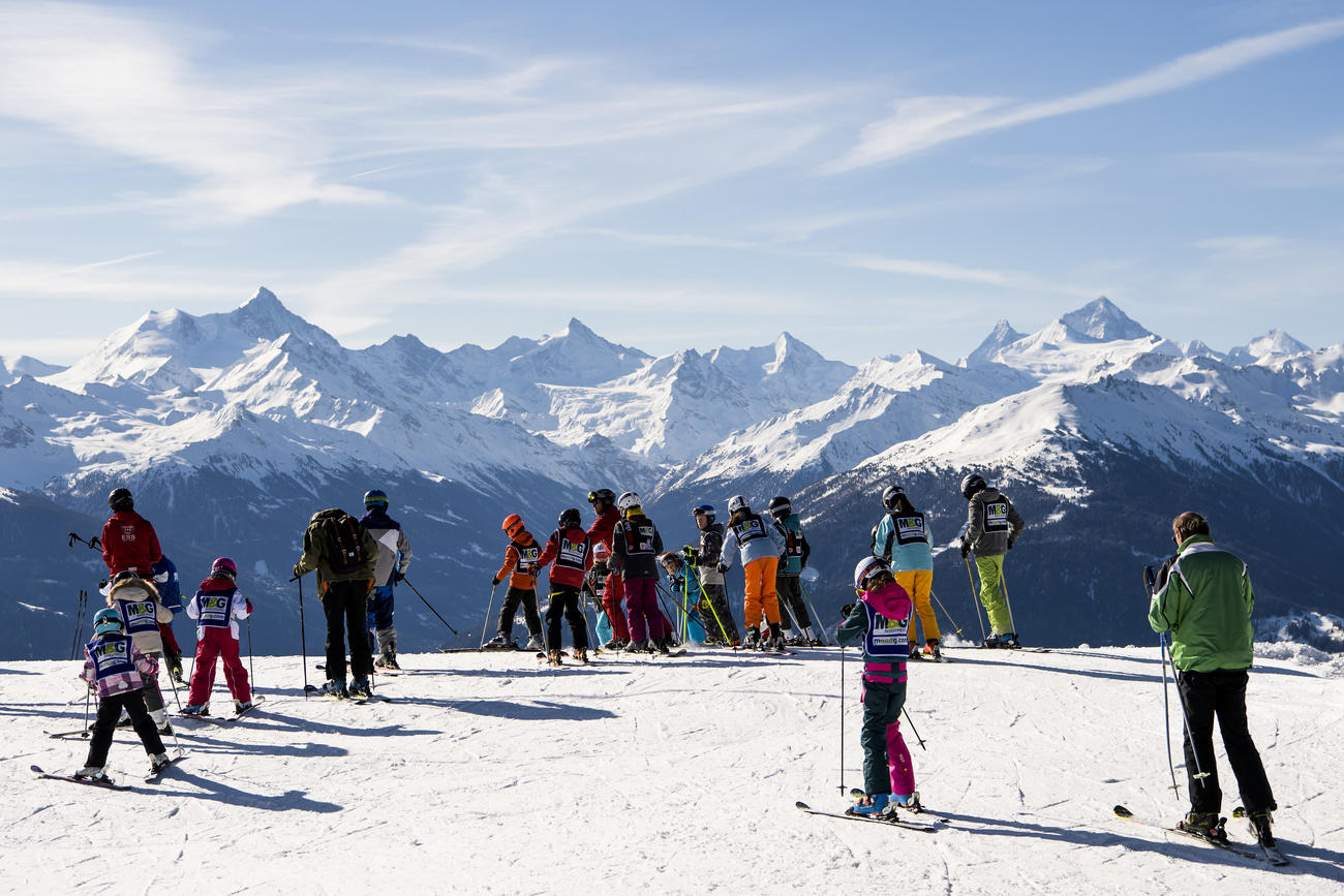Mont-Noble in Switzerland - a group of people standing on top of a mountain.