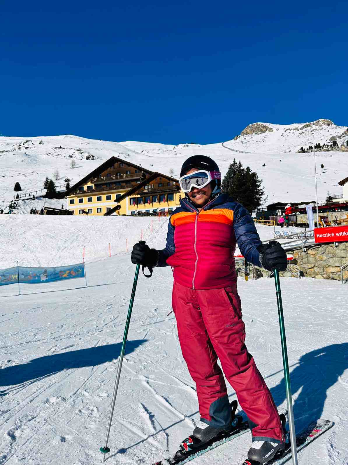St. Moritz Corviglia in Switzerland - a woman in a red ski suit on skis.