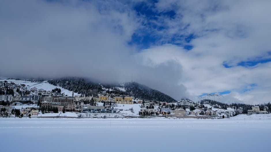 St. Moritz Corviglia in Switzerland - a view of a snowy town in the mountains.