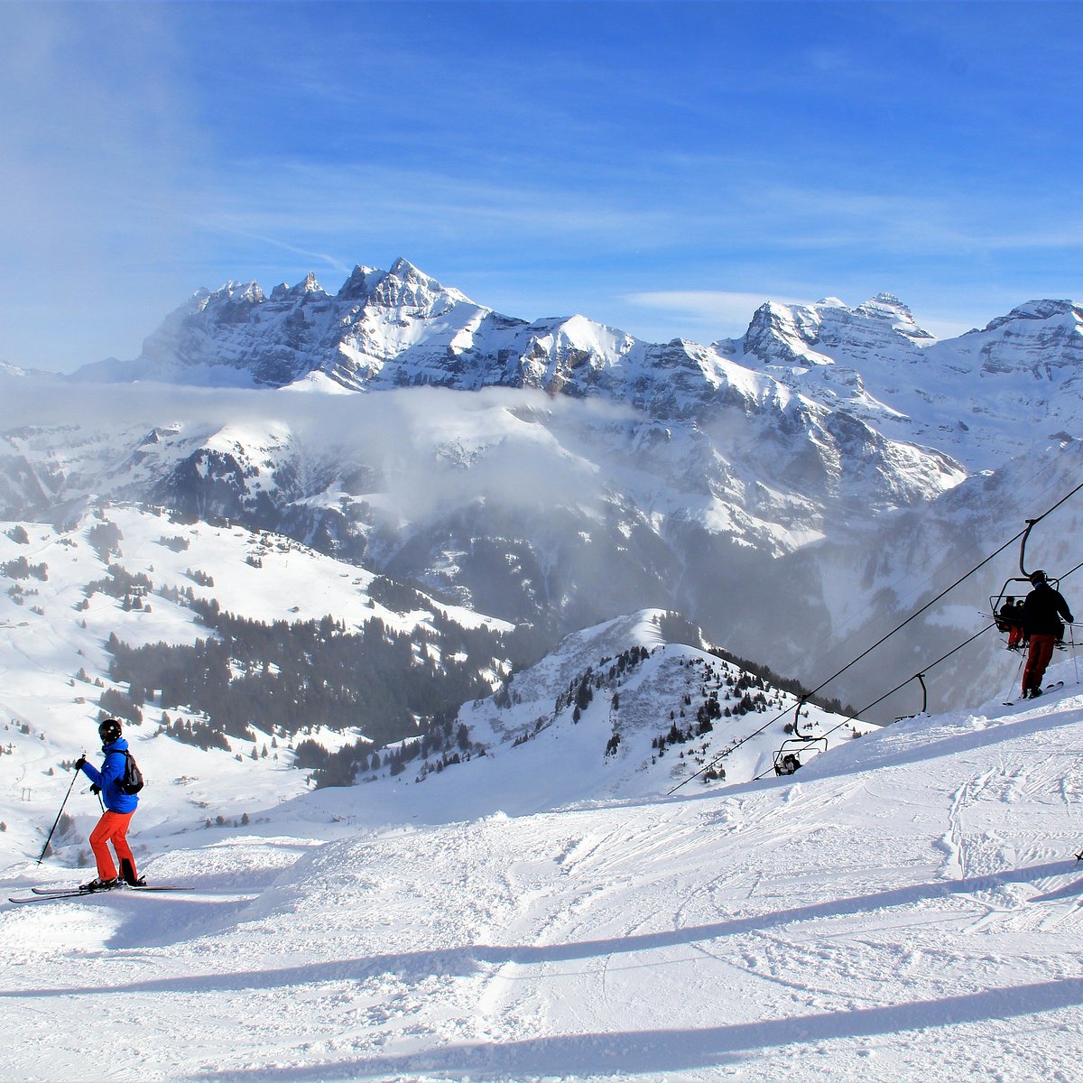 Les Marécottes in Switzerland - a group of people skiing down a snowy slope.
