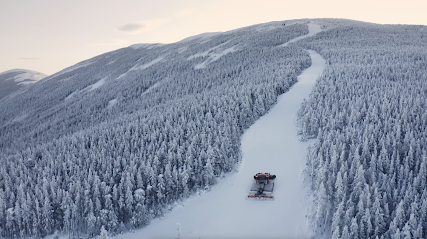 Winter scene at Meiho ski resort in Chūbu, Japan, showcasing snowmobiles, ski lifts, and stunning winter scenery amidst the sporting activities.