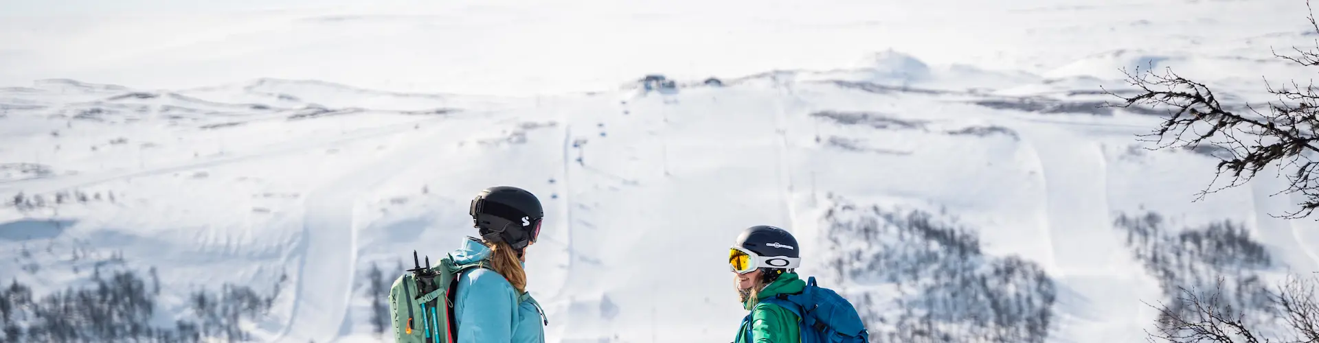 Skiing scene at Tänndalen resort in Northern Sweden, featuring a skier amidst a winter sports activity, possibly with a family or group of people skiing.