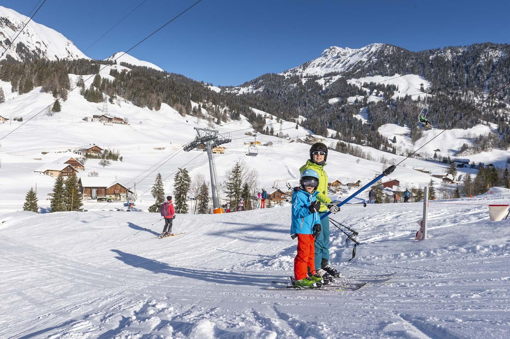 Jaun-Gastlosen Bergbahnen in Switzerland: a young boy on a snowboard at a ski resort.