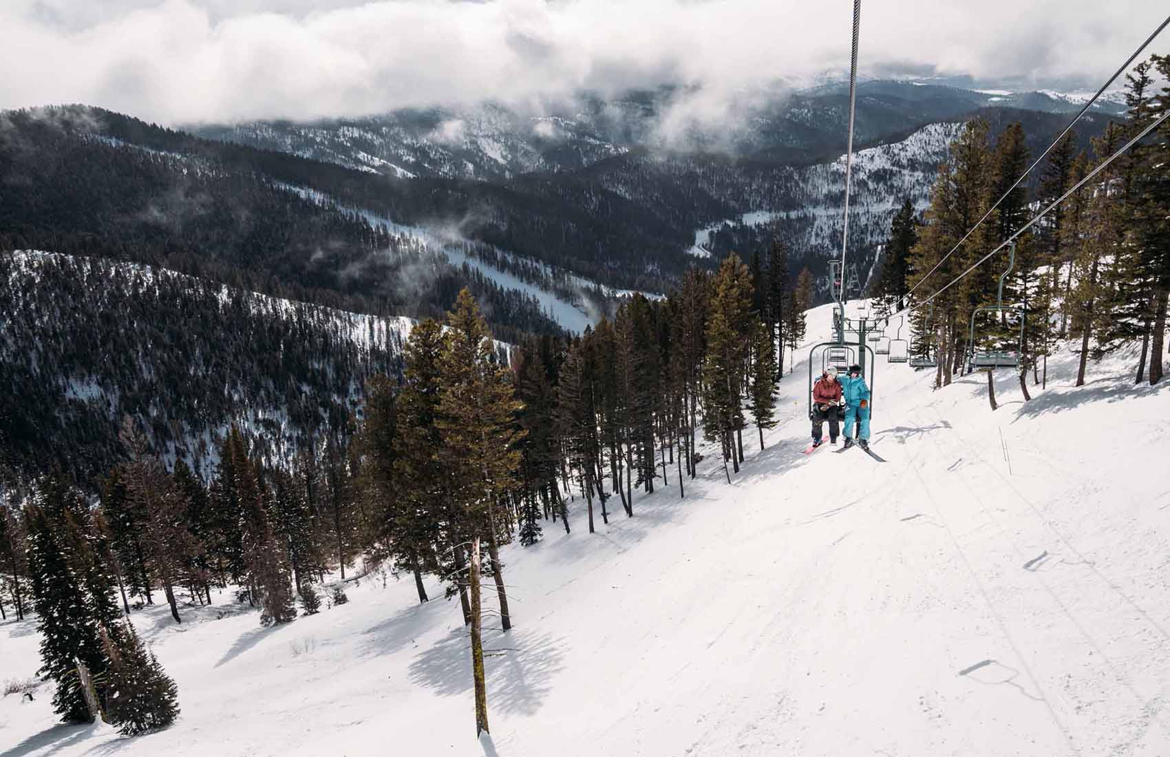 Montana Snowbowl in USA - a person riding a ski board down a mountain.