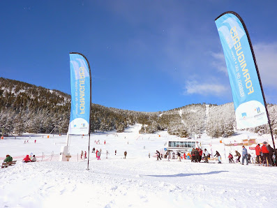 Winter sports scene at Formiguères in France featuring a ski resort and sports center amidst the stunning winter scenery with a skier in action.