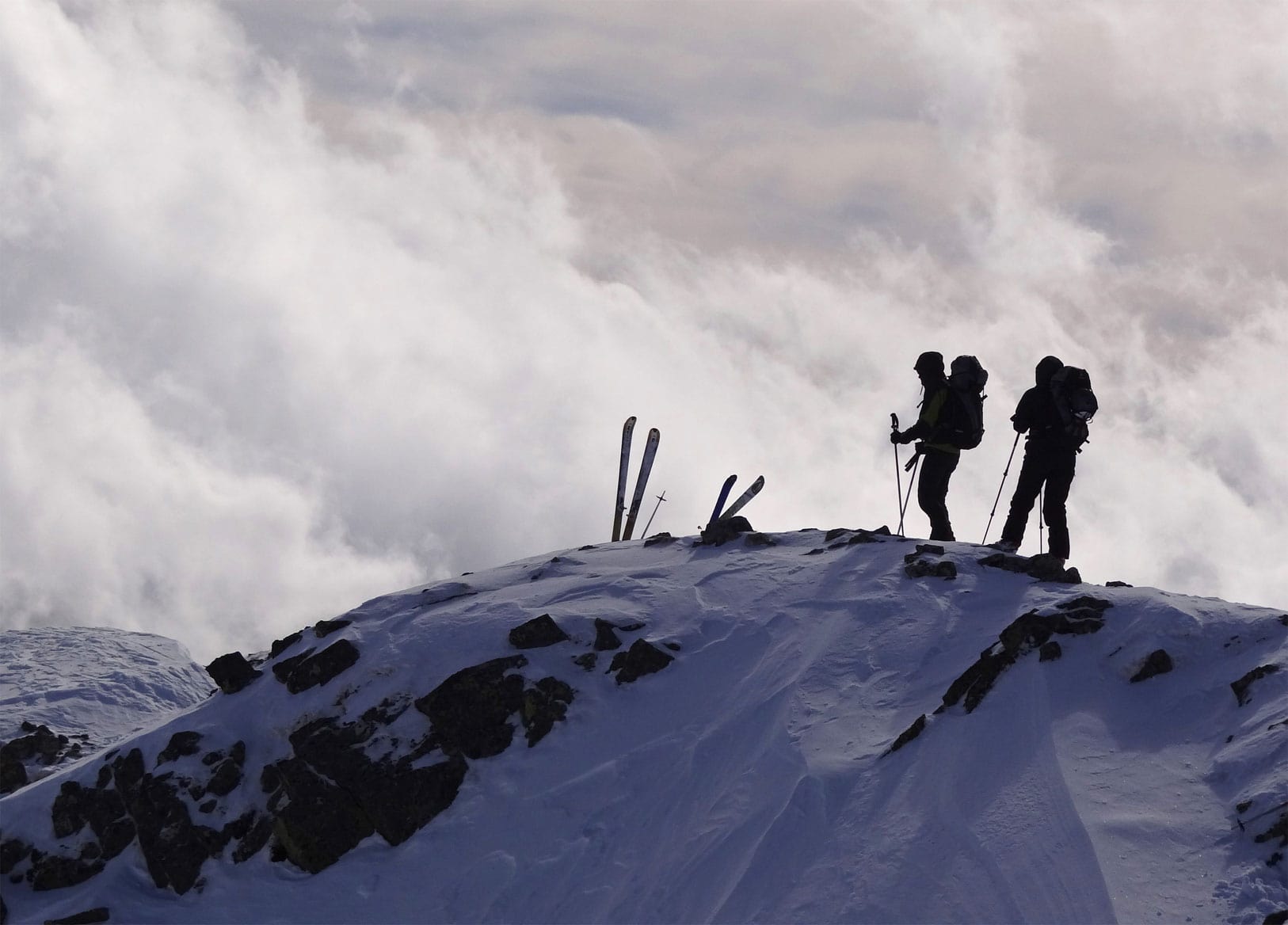 Formiguères in France - two people standing on top of a snowy mountain.