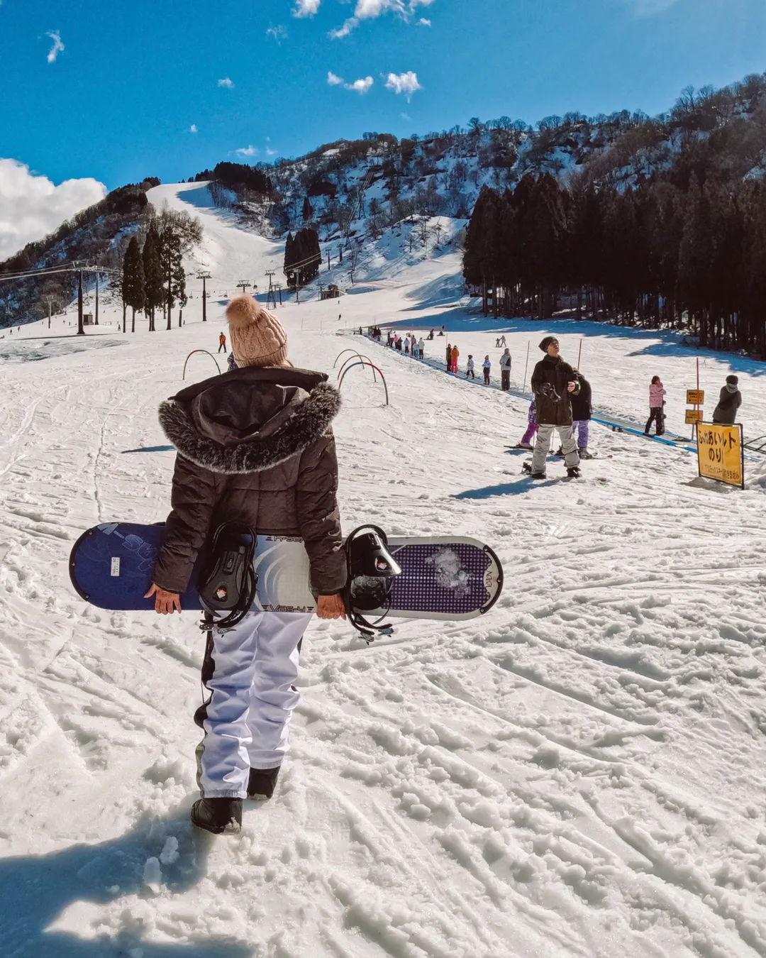 Hakusan Ichirino in Japan - a person walking in the snow with a snowboard.