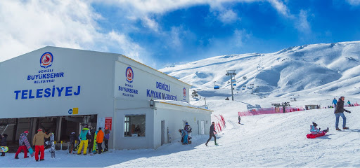 View of Hakusan Ichirino ski resort in Japan featuring a chalet and ski lift amid a bustling winter sports scene.