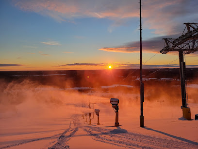 A picturesque winter sports scene in Nikfer Tavas/Denizli Turkey showcasing a ski lift traversing across the snowy ski resort with a skier effortlessly gliding on the slopes amidst the serene winter scenery.