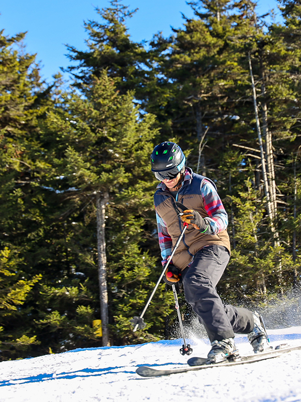 A snowboarder gliding down the snowy slopes of Timberline Mountain in Davis, West Virginia, USA, showcasing the exhilarating winter sports activities available at this stunning location.