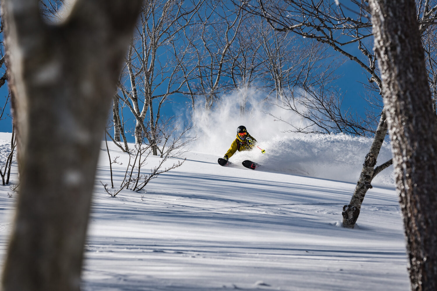 Geto Kogen in Japan - a person riding a snowboard down a snowy slope.