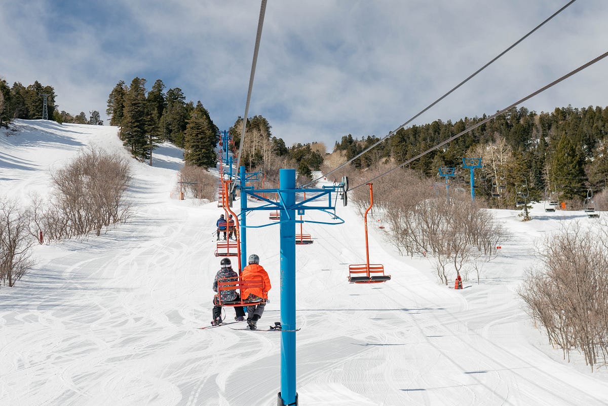 Sandia Peak in USA - a man riding a ski board down a snowy slope.