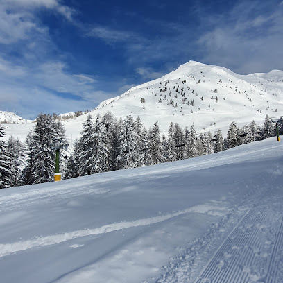 A winter sports scene at Sandia Peak in New Mexico, featuring a ski resort with a charming chalet, a skier swiftly descending the snow-covered slopes, and a breathtaking view of the mountain ranges.
