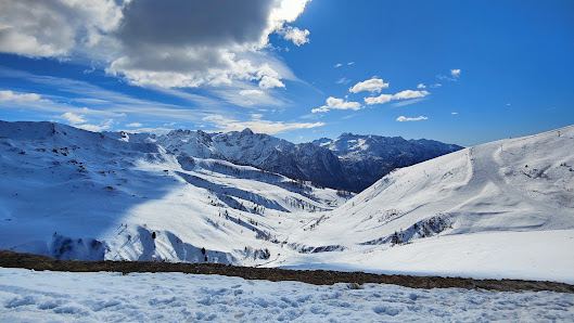 Ski resort in Foppolo, Italy with a cozy chalet nestled in stunning winter scenery. Snow-covered mountain acts as the backdrop of winter sports scene.
