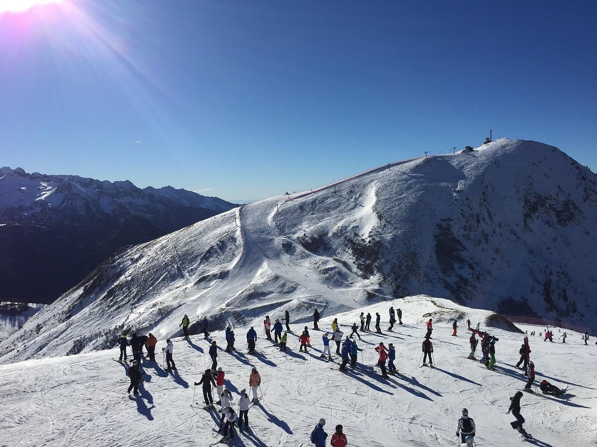 Foppolo - Carona - Brembo Ski in Italy - a group of people skiing down a snow covered mountain.