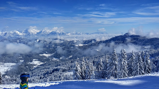 Winter scene at Foppolo-Carona-Brembo Ski resort in Lombardy, Italy. The resort is nestled amongst the mountains, showcasing beautiful winter scenery and a charming challet.