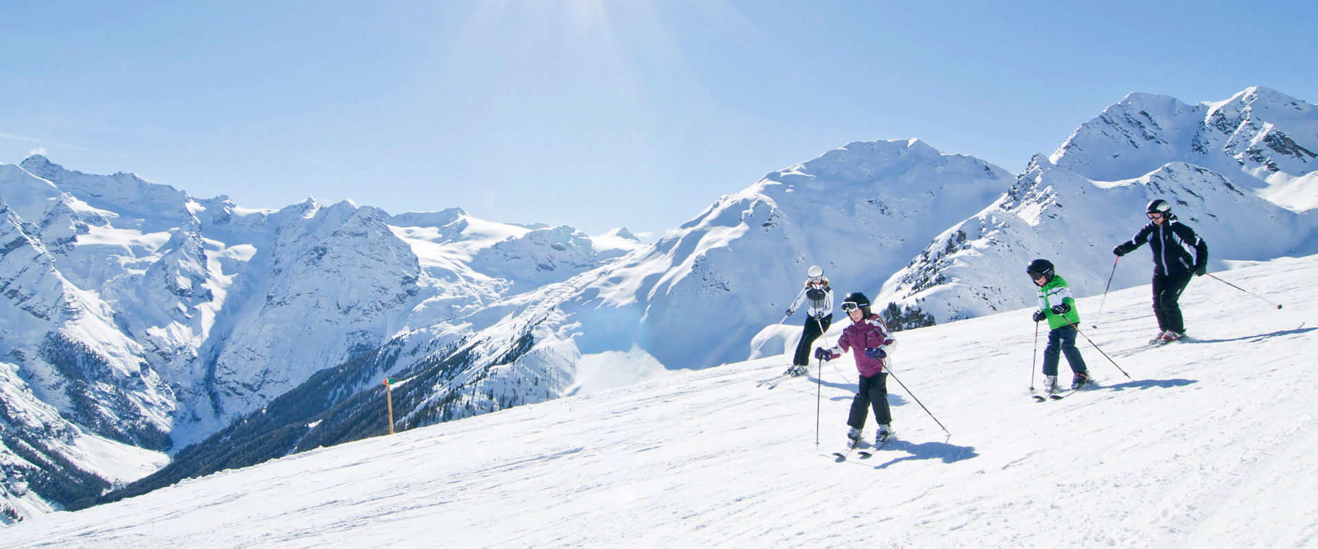 Rittner Horn in Italy - a group of people skiing down a mountain.