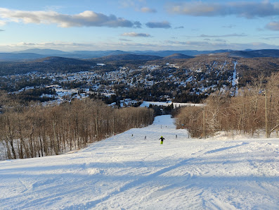 Winter scene at La Colmiane ski resort in France showcasing a skier going down the snow-covered slopes, with a ski lift visible in the backdrop.