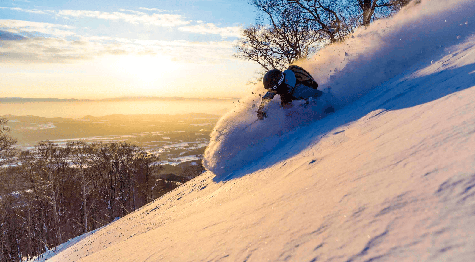 Shizukuishi in Japan - a person riding a snowboard down a snowy slope.