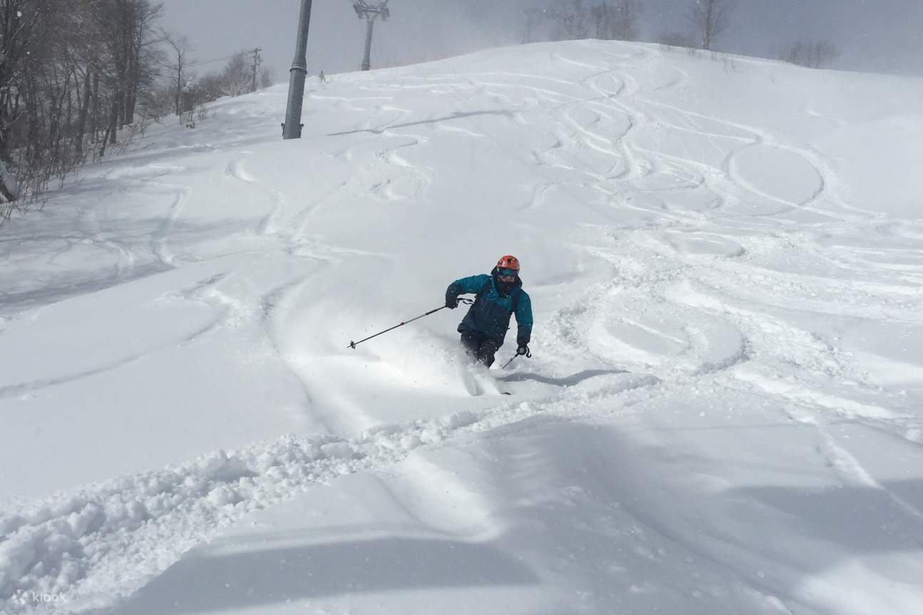 Shizukuishi in Japan - a person skiing down a snow covered slope.