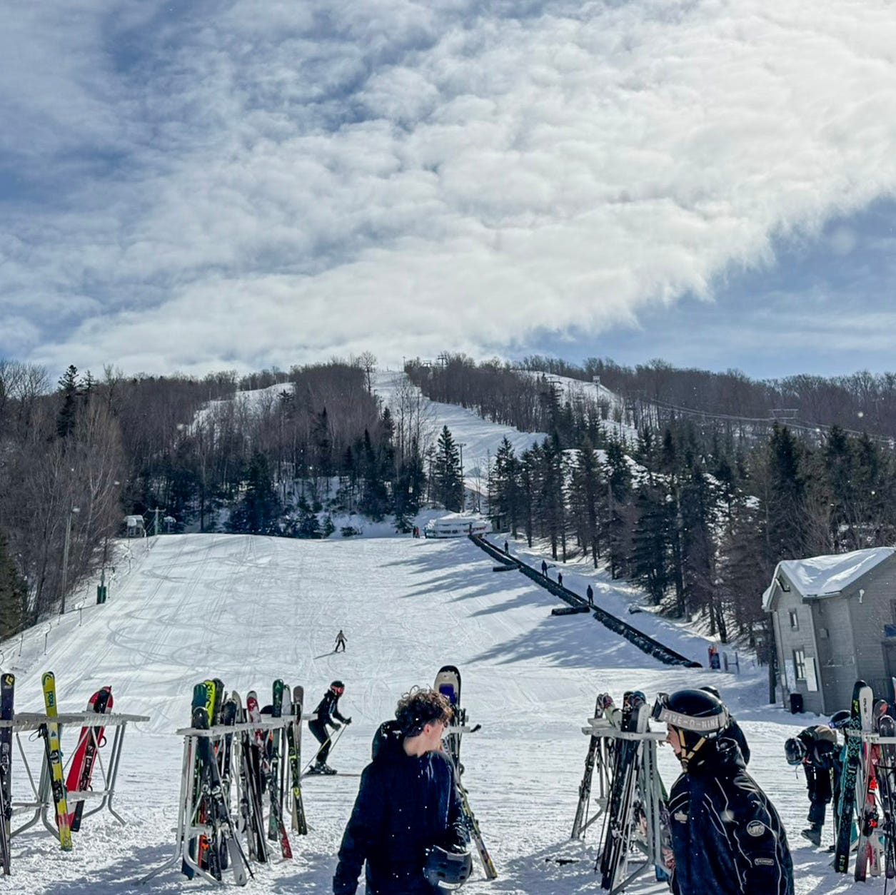 Le Relais in Canada - a group of people standing on top of a snow covered slope.