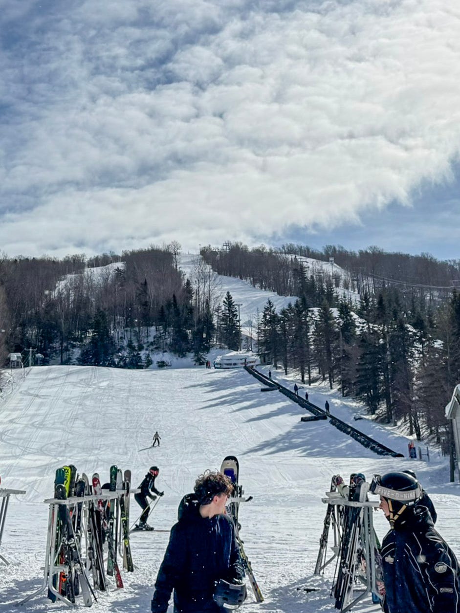 Le Relais in Canada - a group of people standing on top of a snow covered slope.