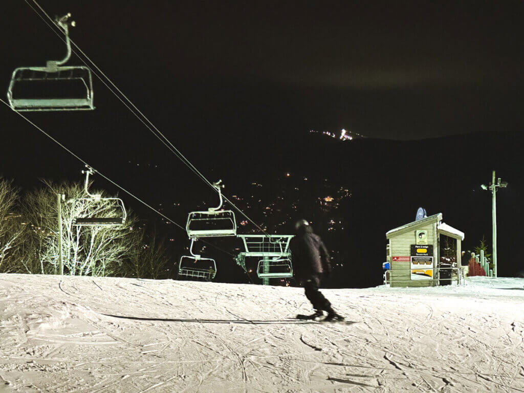 Le Relais in Canada - a man riding a snowboard down a snowy slope.