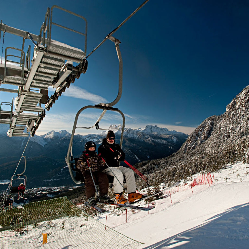 San Vito di Cadore in Italy - a ski lift going up a snowy mountain.