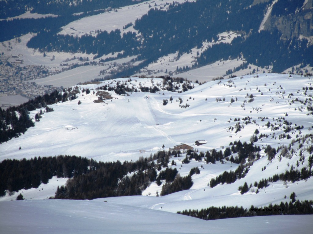Sesselbahn und Skilifte in Switzerland - a snow covered mountain with trees in the background.