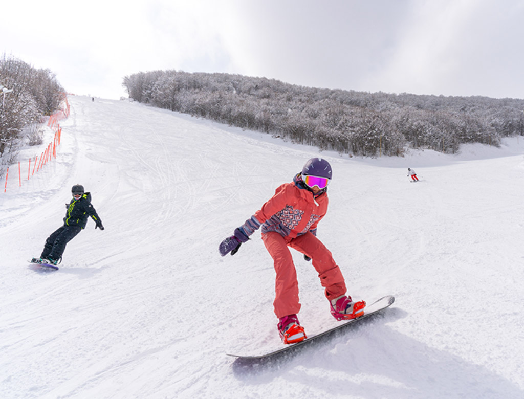 Tsaghkadzor in Armenia - a person on a snowboard going down a hill.
