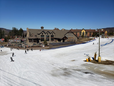 Ski resort at Mountain Creek – Vernon, New Jersey, bustling with activity, featuring a scenic ski lift and skiers enjoying winter sports.